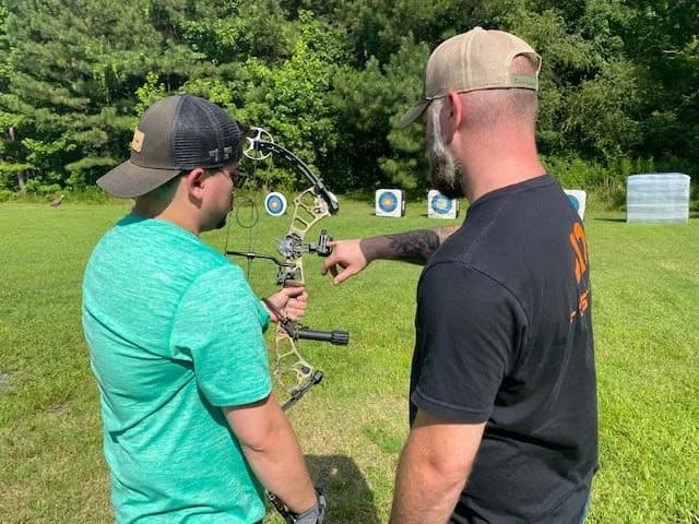 Mentee learning archery